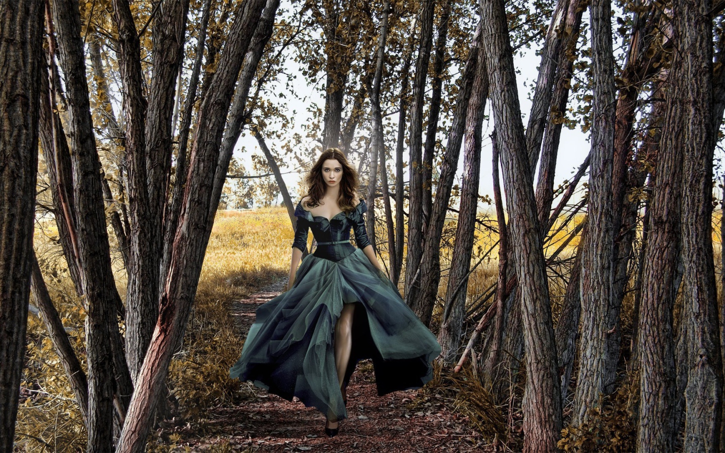 Девушка в черном платье среди деревьев