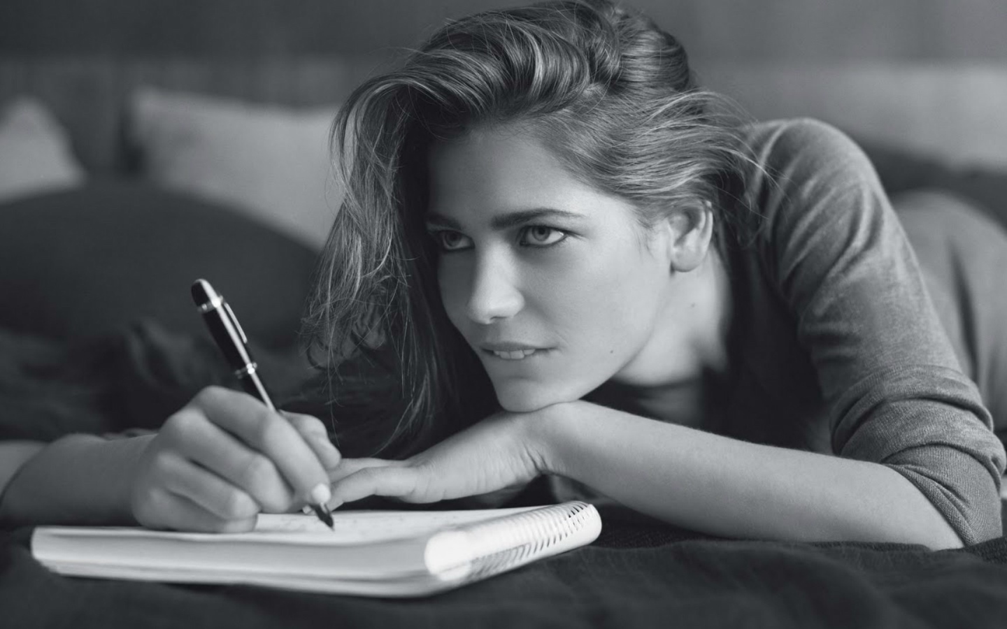 Девушка пишет в блокноте