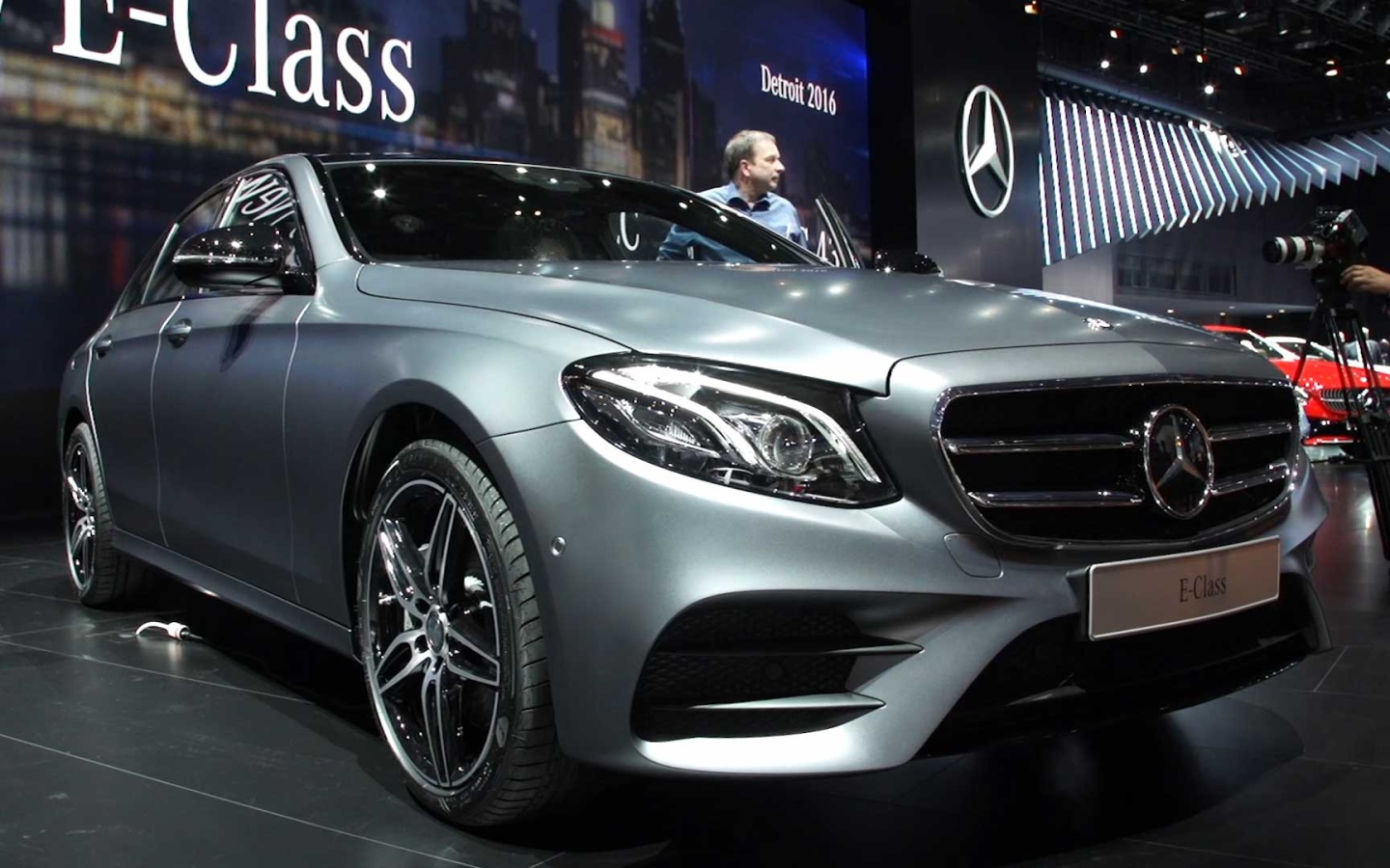 Презентация серебристого автомобиля Mercedes-Benz E-Class 2017 года 