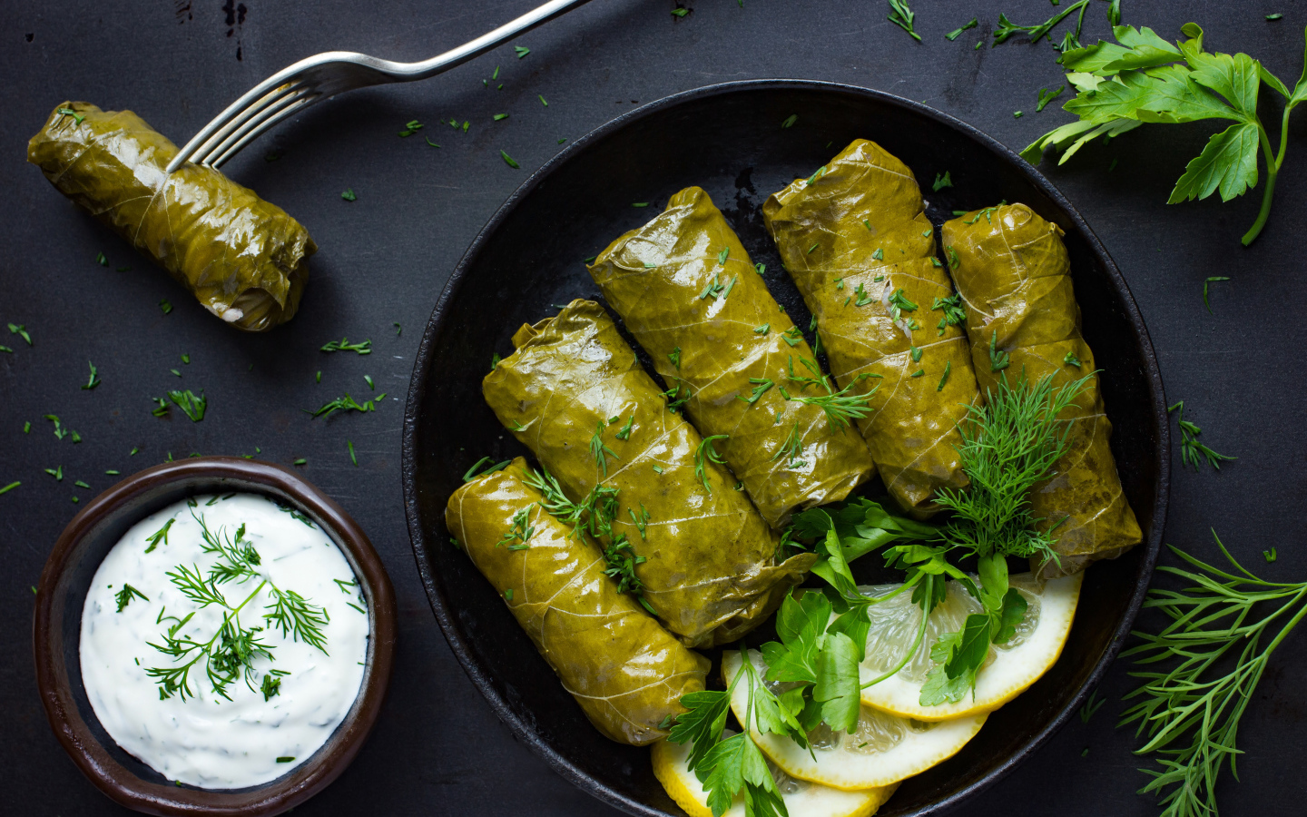 Аппетитная долма с кусочками лимона на столе 