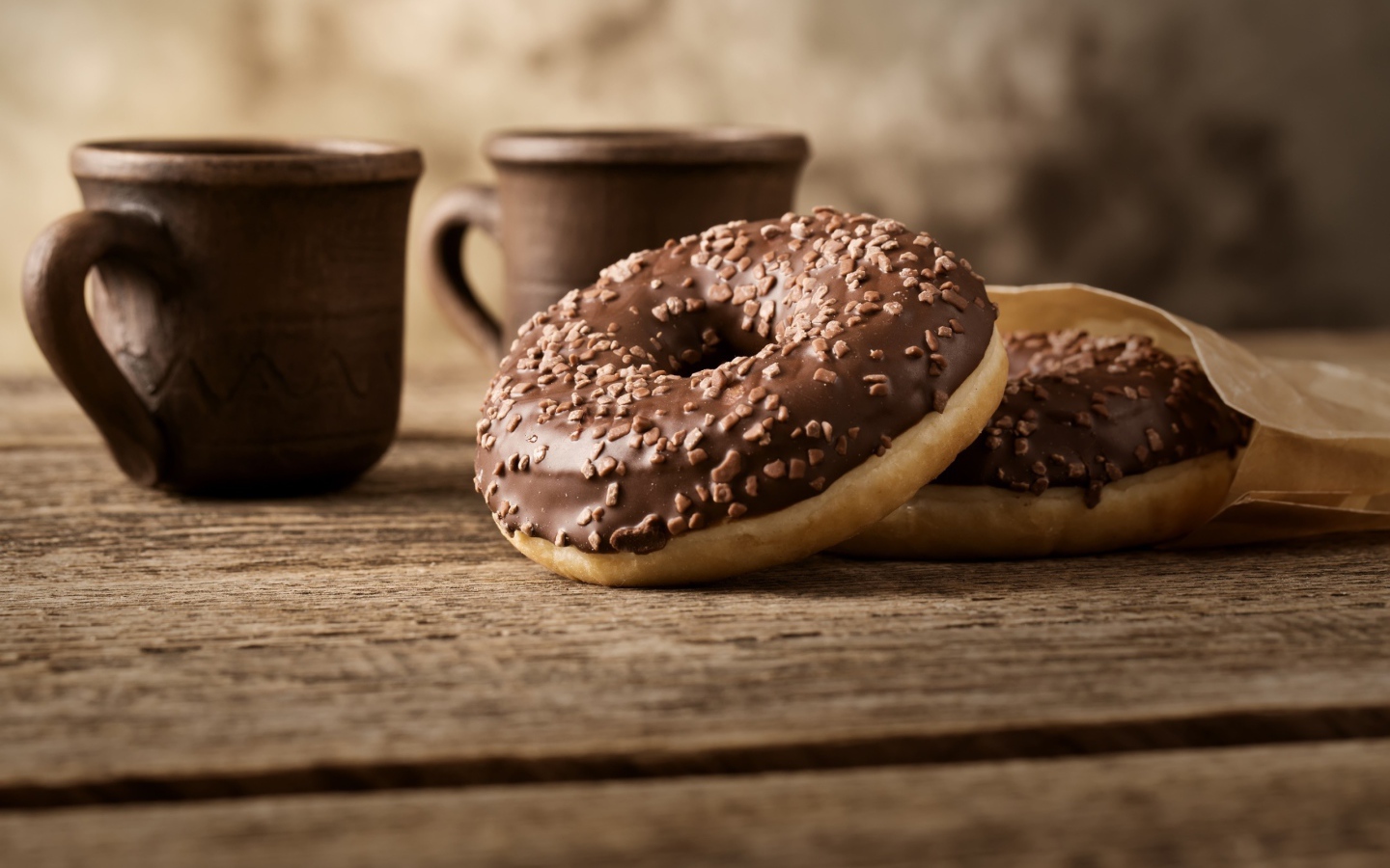 Сладкие круглые пончики с шоколадом на столе 