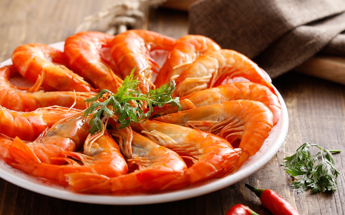 Appetizing boiled shrimps on a plate with parsley greens