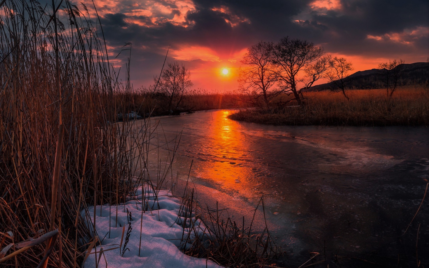 Sunset over an ice-covered river