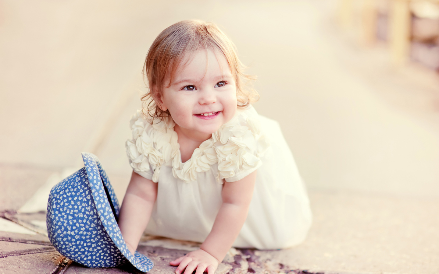 Милая улыбающаяся девочка в белом платье