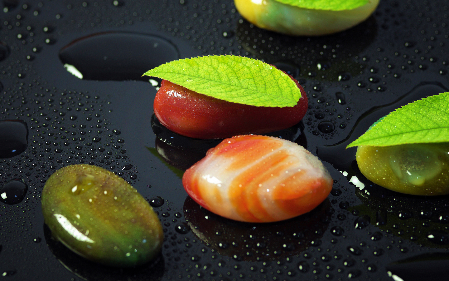 Красивые камни на черной мокрой поверхности