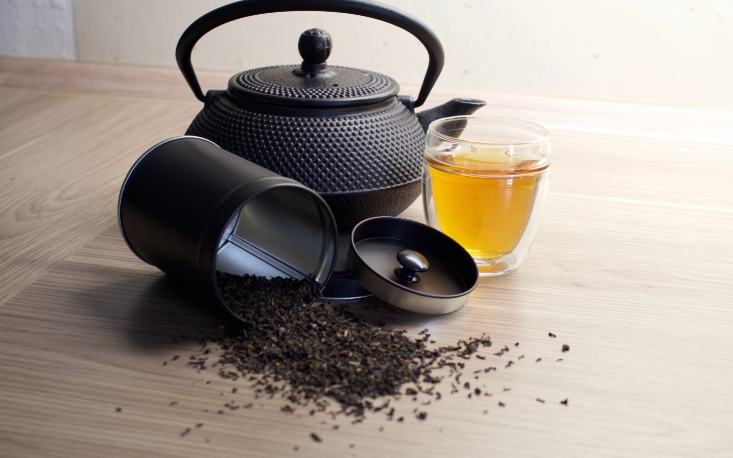 Черный чай на столе с чайником и чашкой