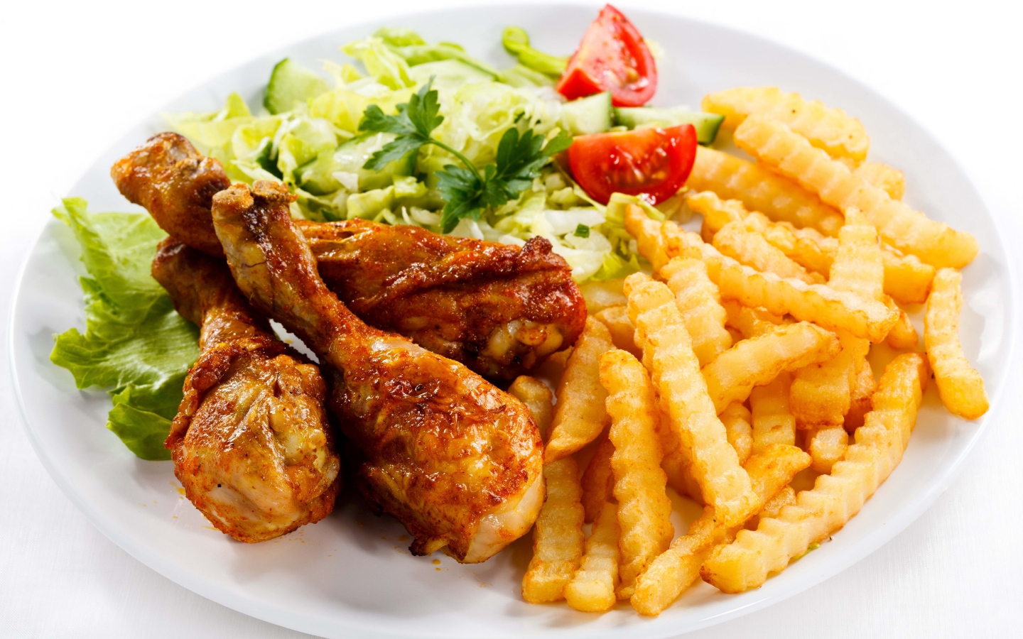 Fried chicken legs with french fries and salad