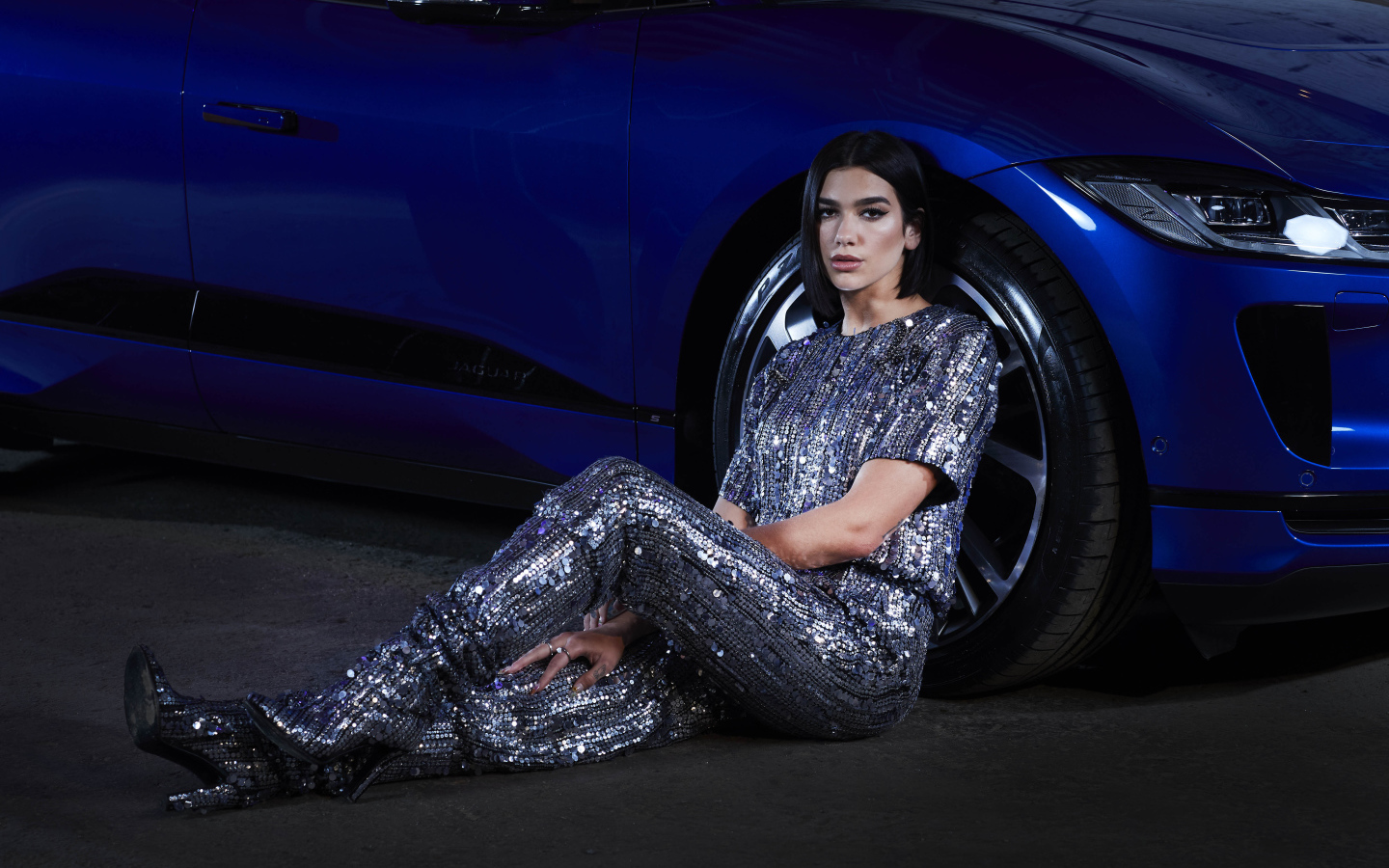 Певица Дуа Липа в блестящем костюме у машины