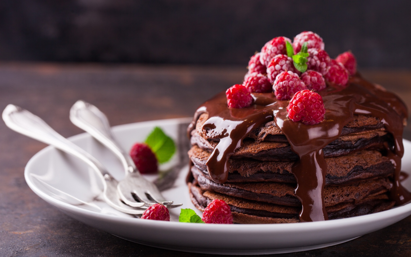 Chocolate Pancakes on a Plate with Chocolate and Raspberry Berries