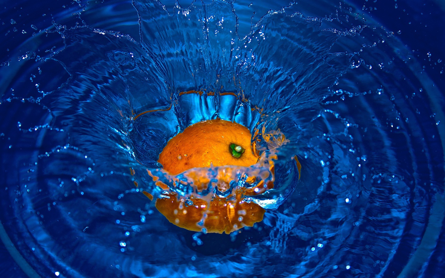 Оранжевый апельсин упал в воду 