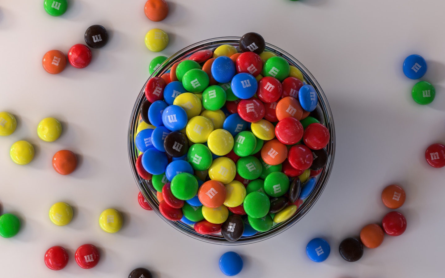 Multicolored sweets with bowl on gray table
