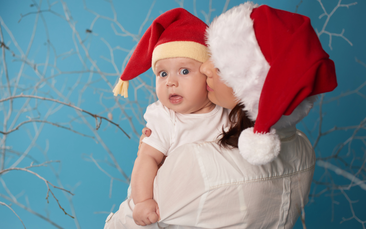 Маленький ребенок в новогоднем костюме на руках у мамы