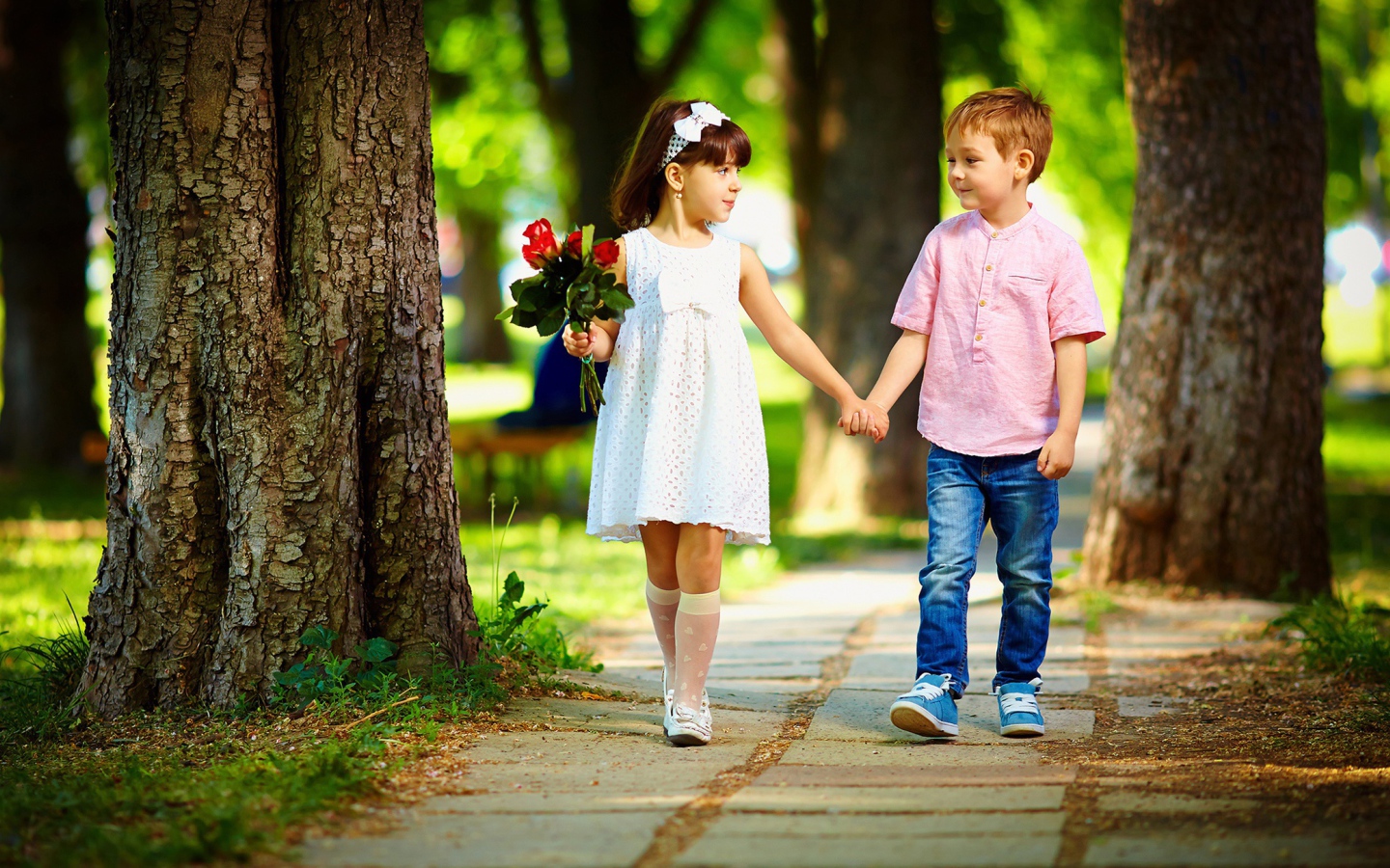 Мальчик и девочка гуляют по парку