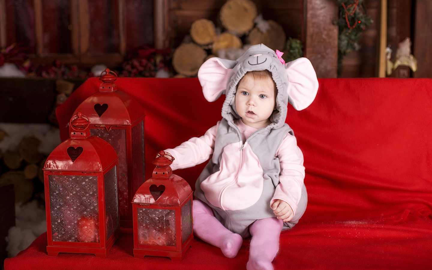 Маленький мальчик в костюме мышонка с фонарями на диване