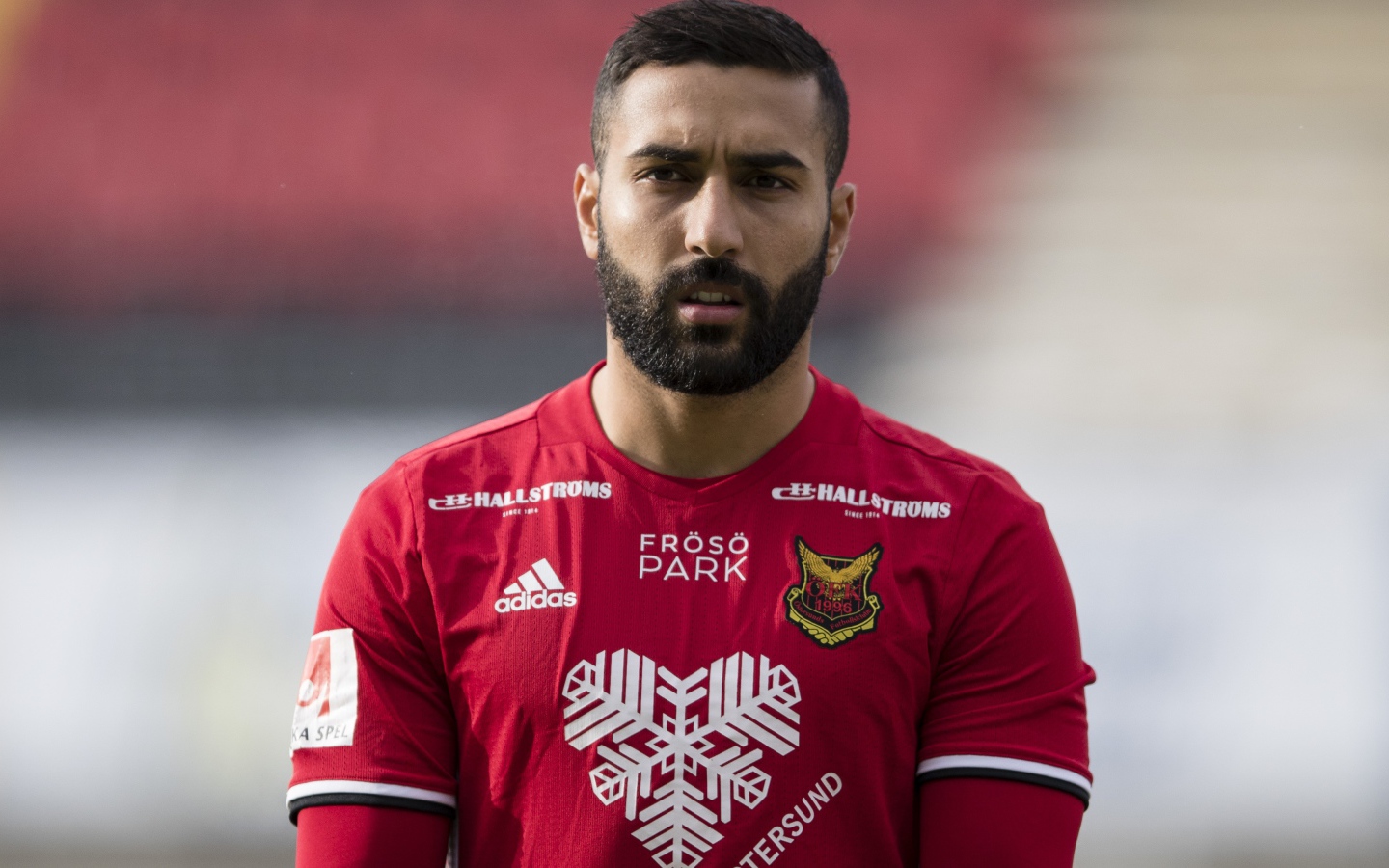 Football player Saman Goddos in red