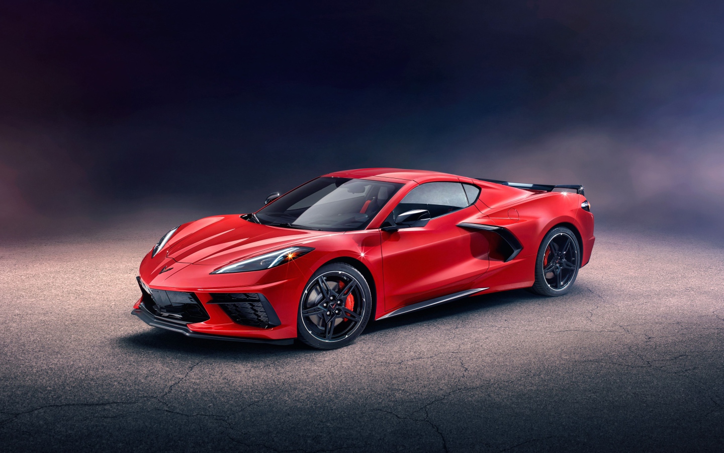 Красный автомобиль Chevrolet Corvette Stingray Z51 Preserial  на сером фоне