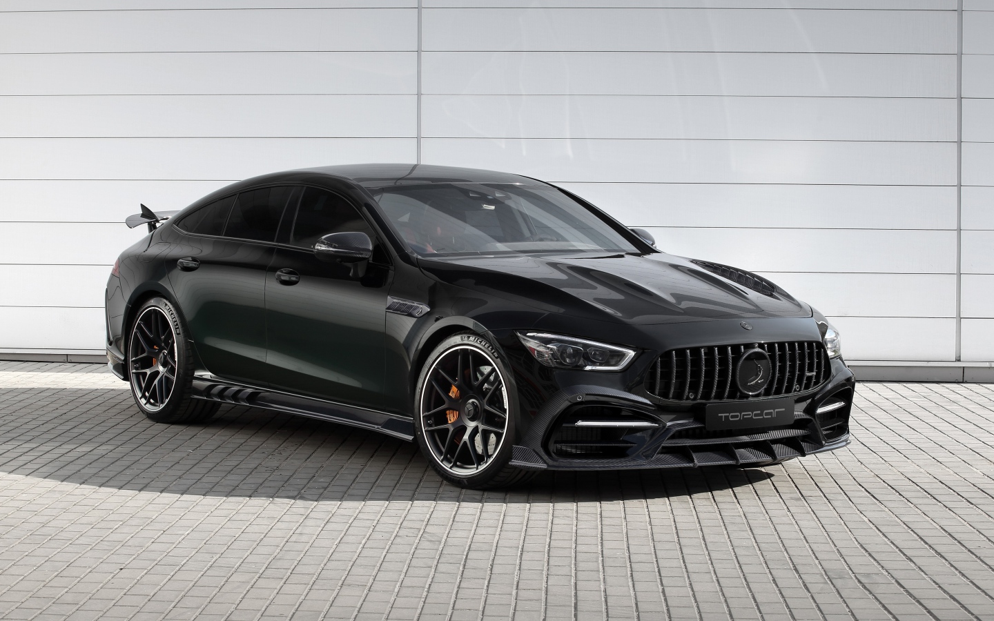 Черный автомобиль  Mercedes-AMG GT 63 S 4MATIC+ 4-Door Coupé Inferno 2020 года у гаража