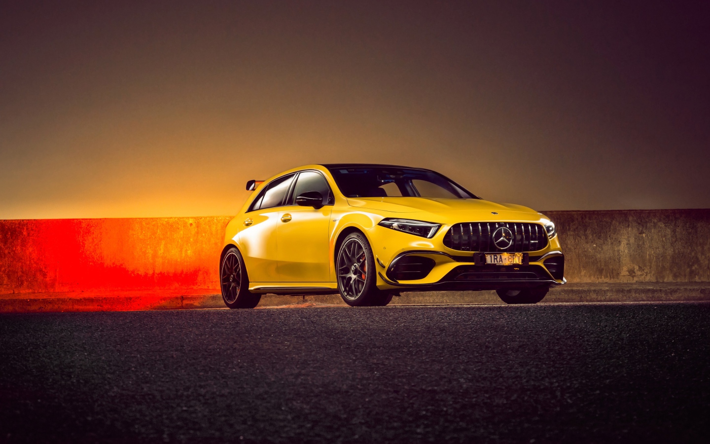 Желтый автомобиль Mercedes-AMG A 45 S,  2020 года на асфальте 