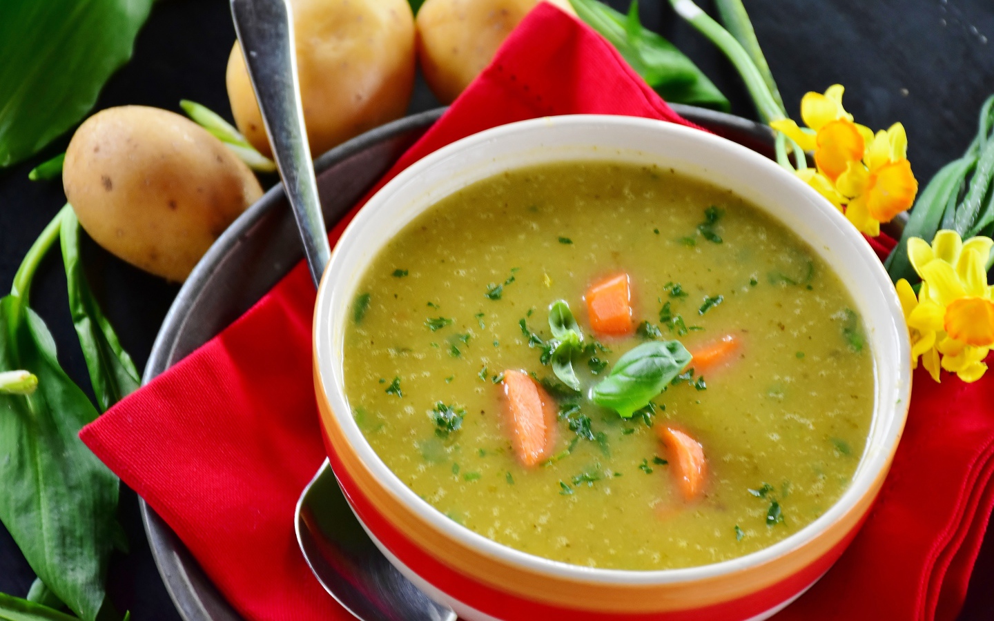 Puree pea soup on the table with potatoes