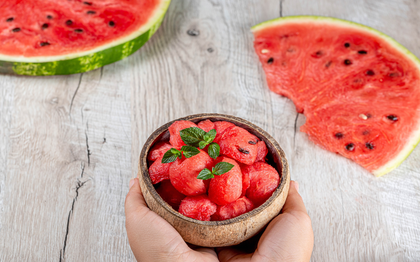 Watermelon pulp in a bowl in hands