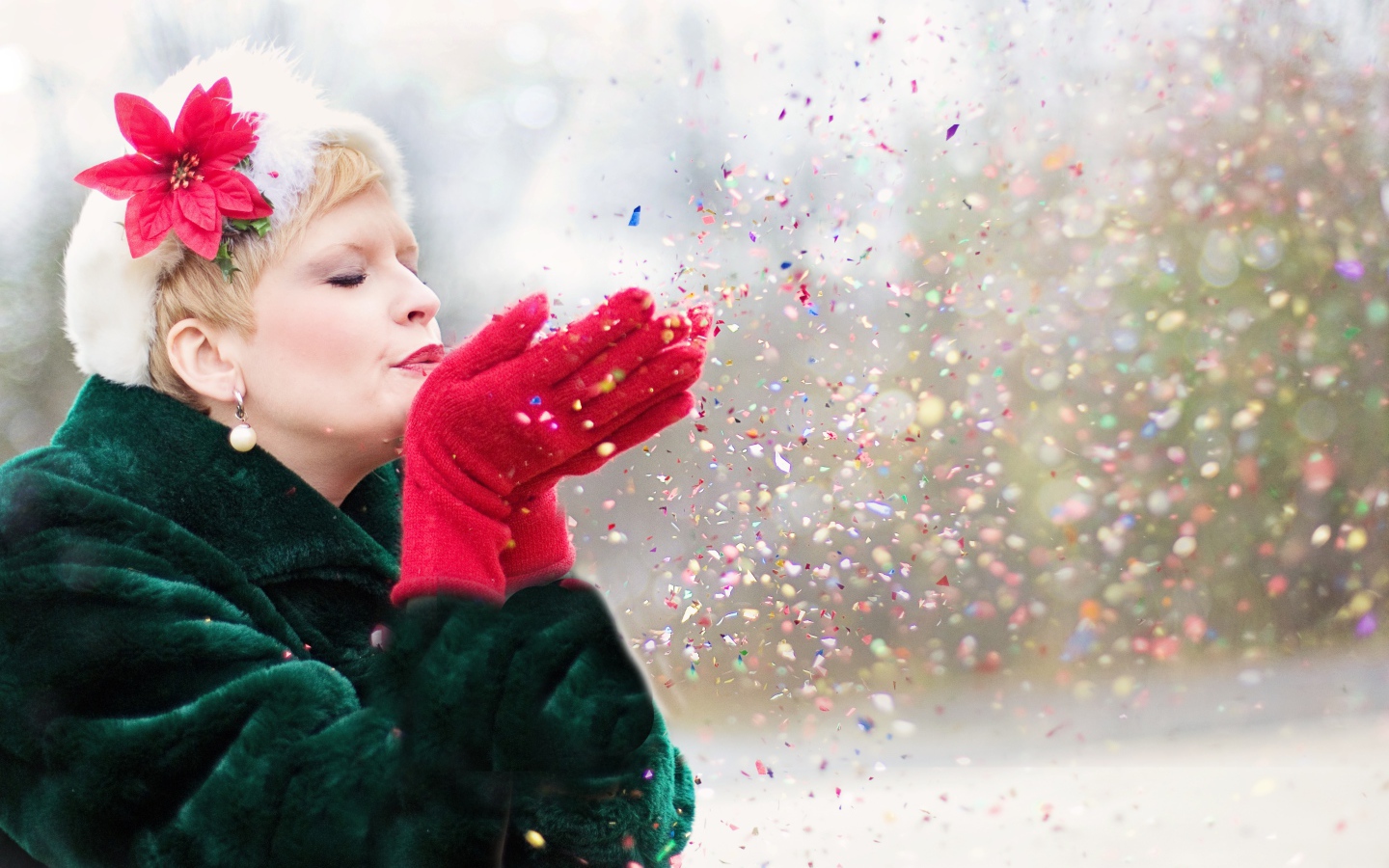 Женщина в шубе сдувает конфетти с ладоней