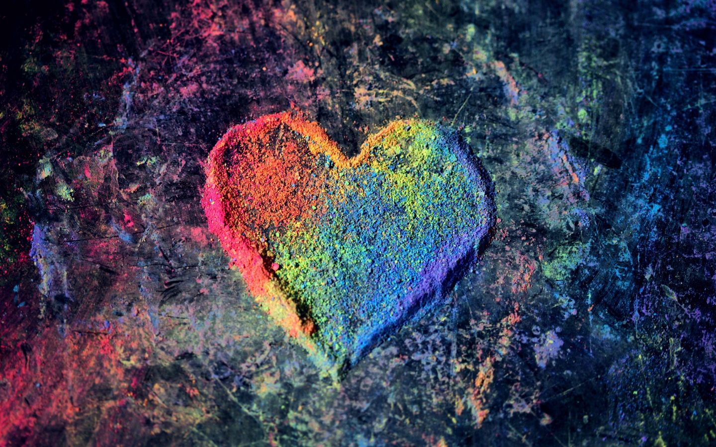 Multi-colored heart from dry paint on a gray background