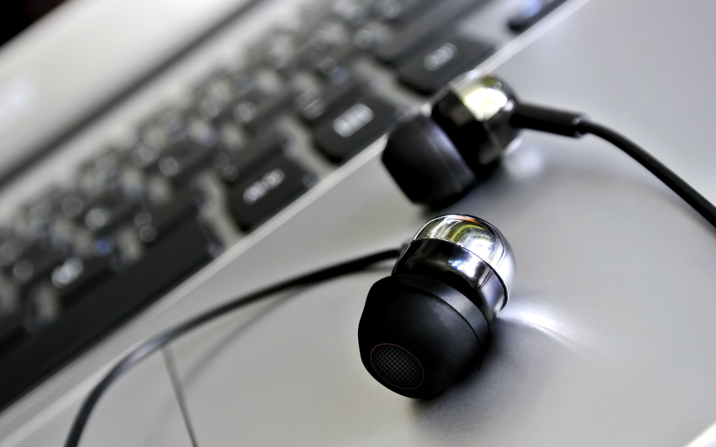 Headphones lie near the keyboard close-up