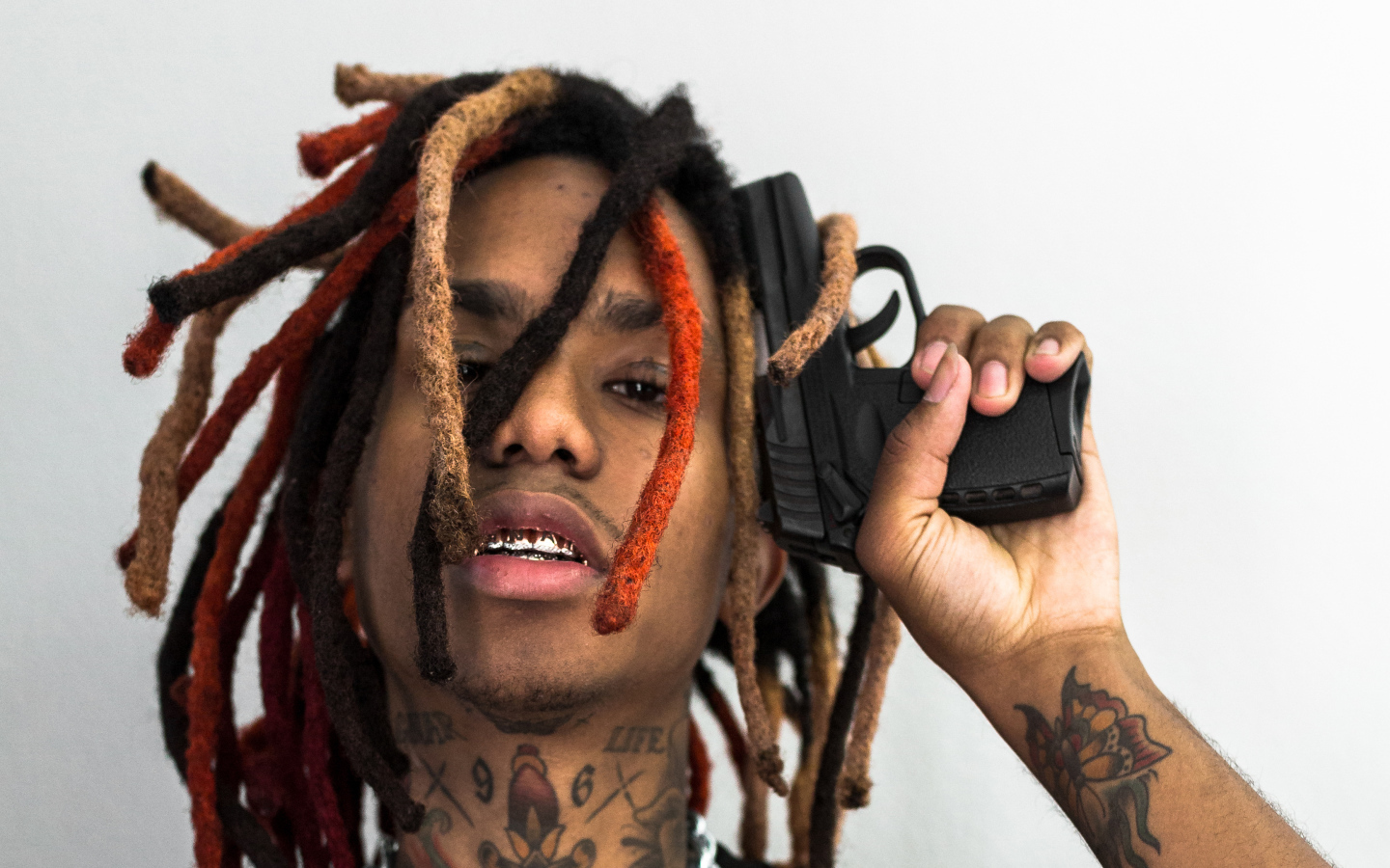 Rapper Lil Gnar with a gun in his hand