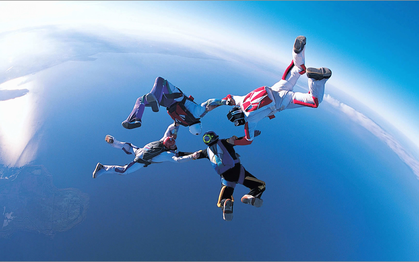Four skydivers in the air