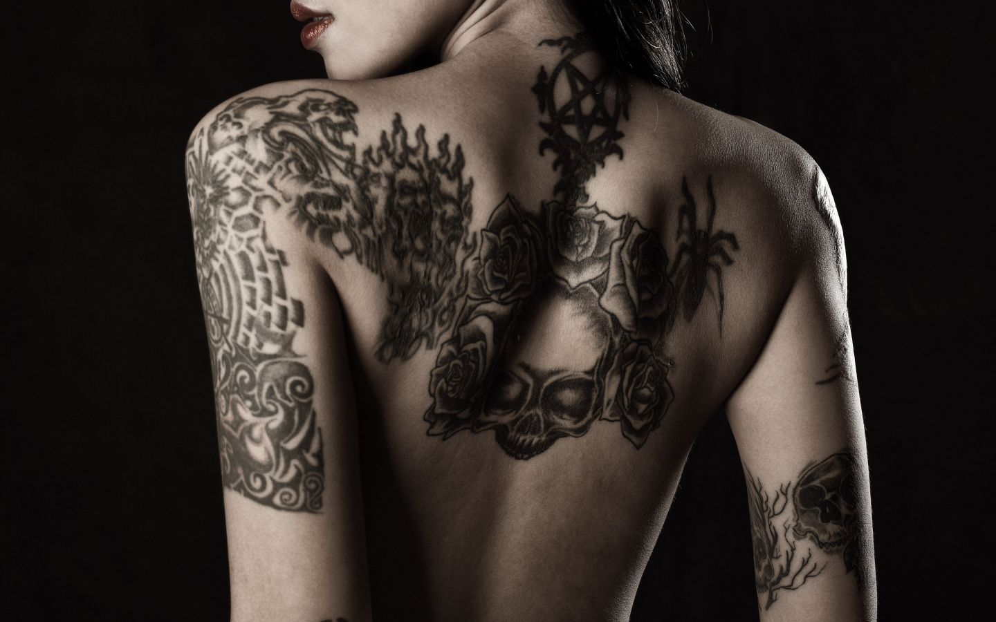 Girl with tattoos on her arms and back