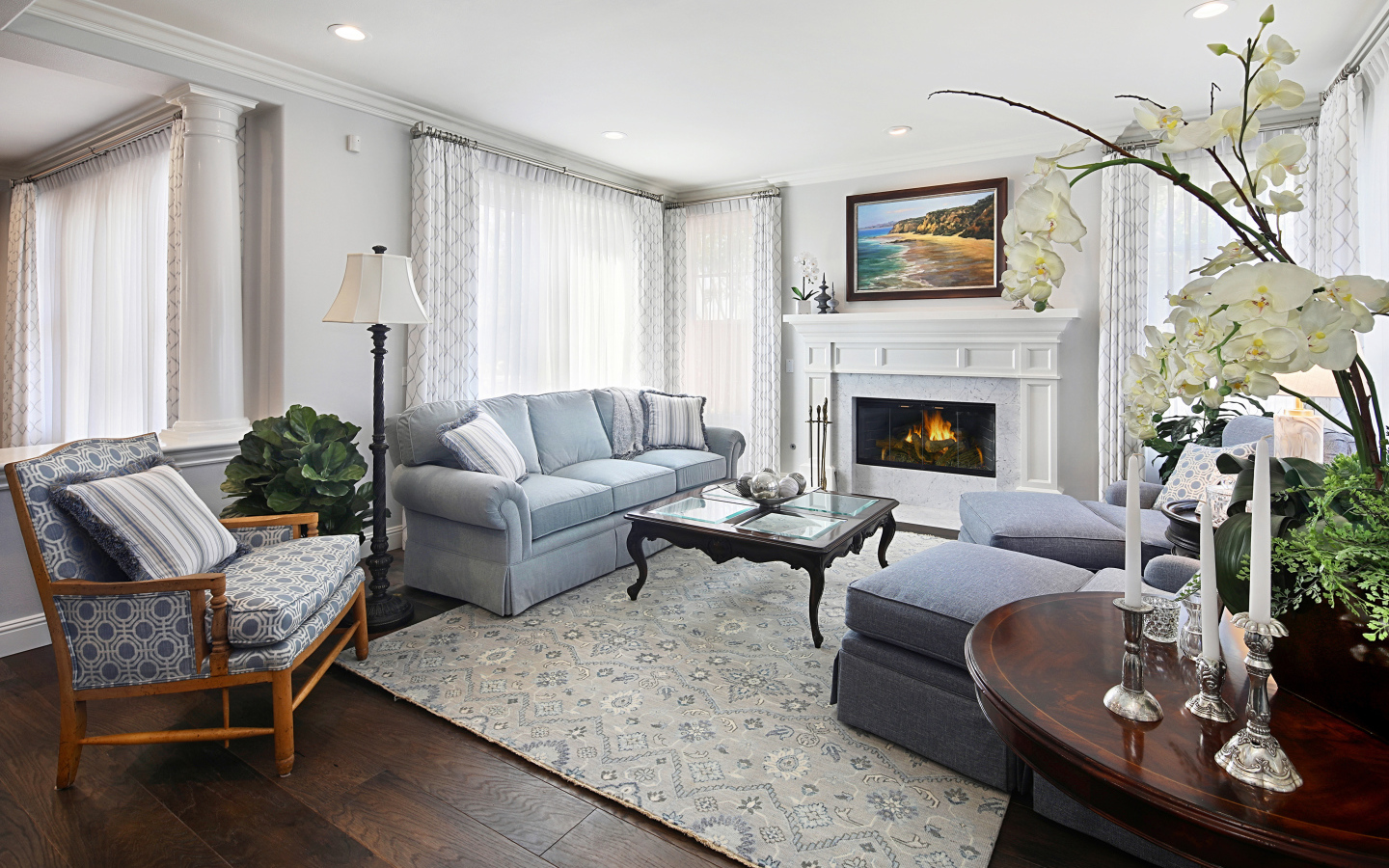 Large living room with a fireplace and fresh flowers