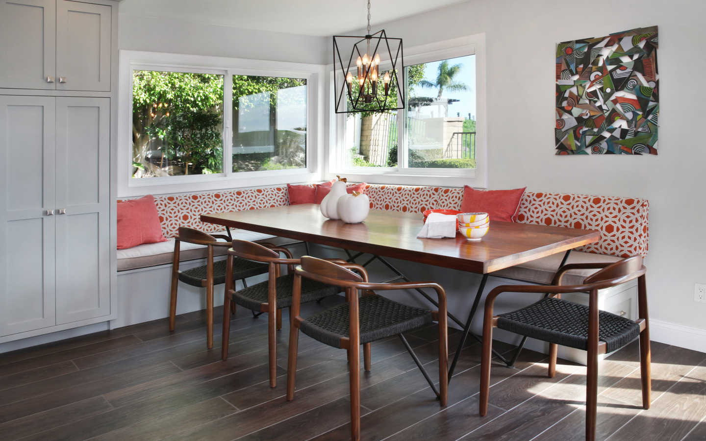 Большой деревянный стол и диван у окна в гостиной 