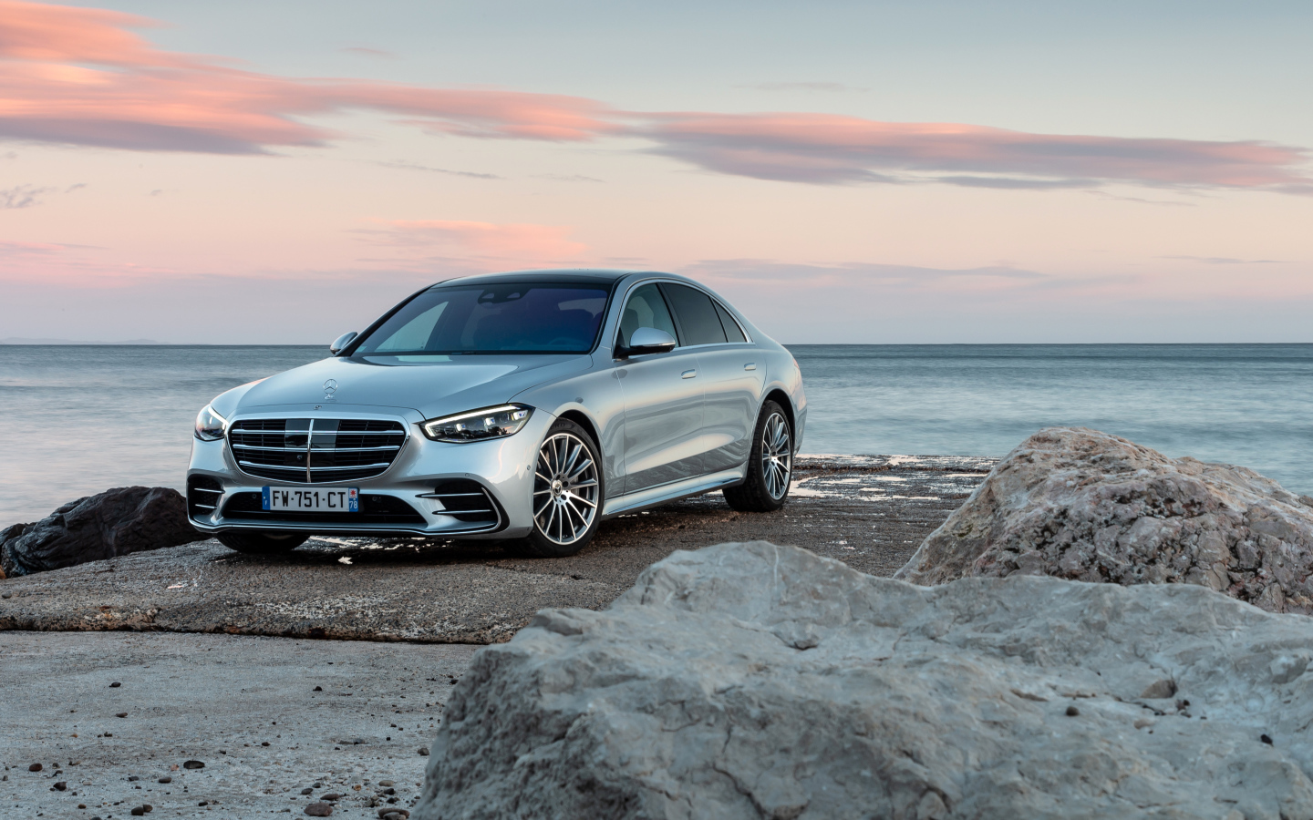Silver car Mercedes-Benz S 350 D AMG Line against the background of the sea