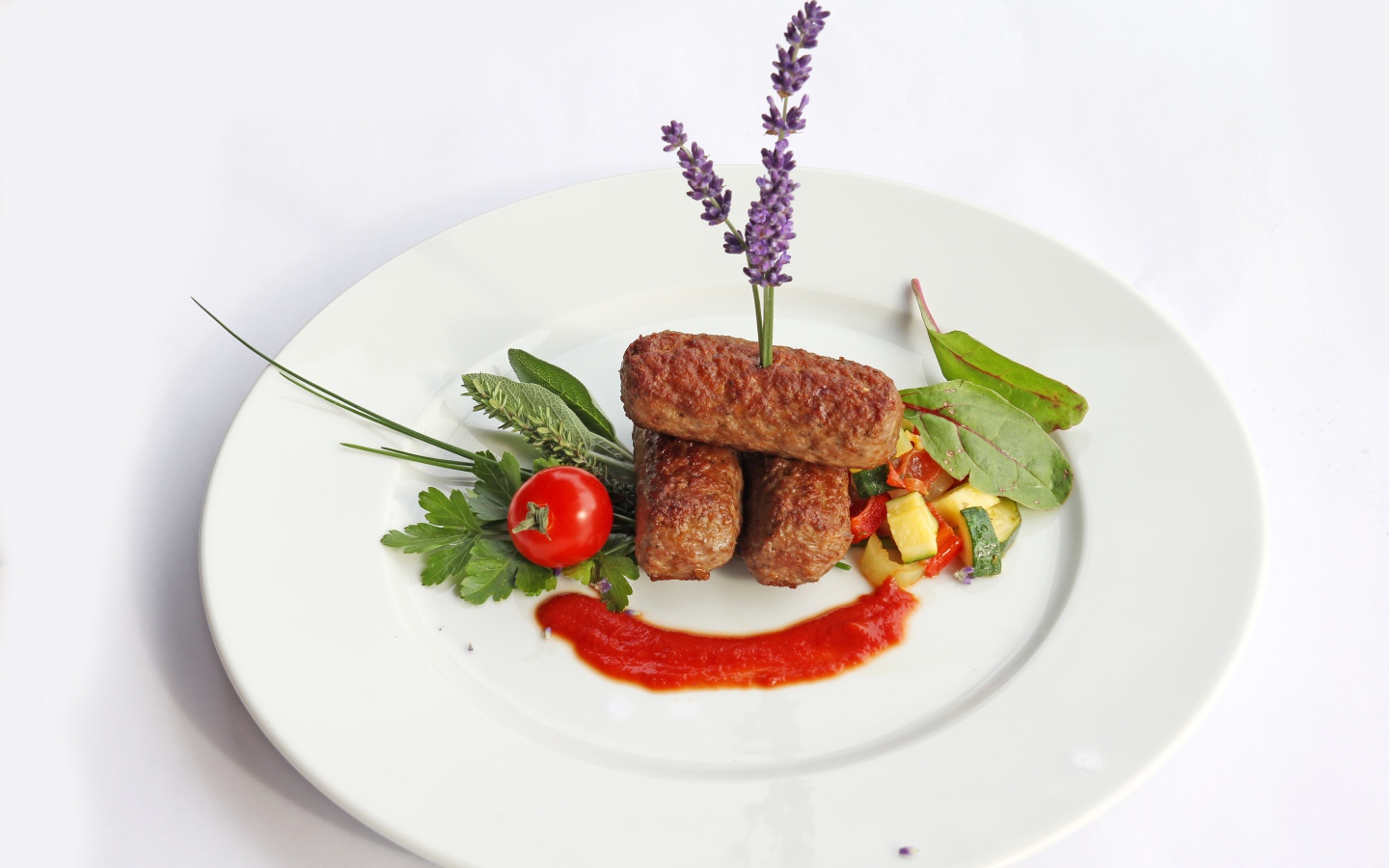 Meat sticks on a plate with herbs and sauce