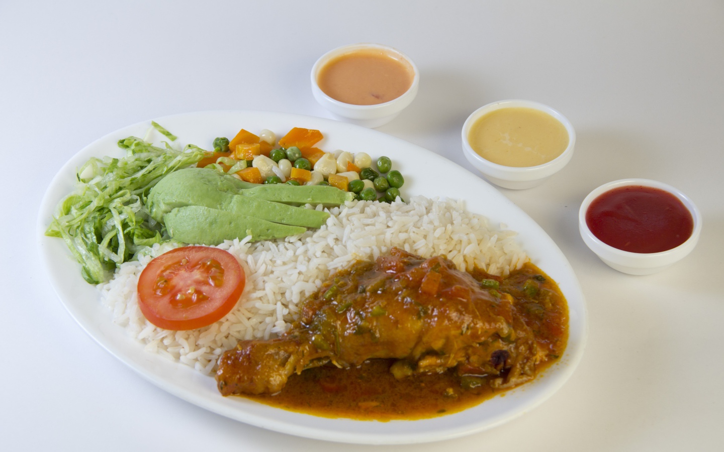 Rice with chicken and vegetables on the table with sauce