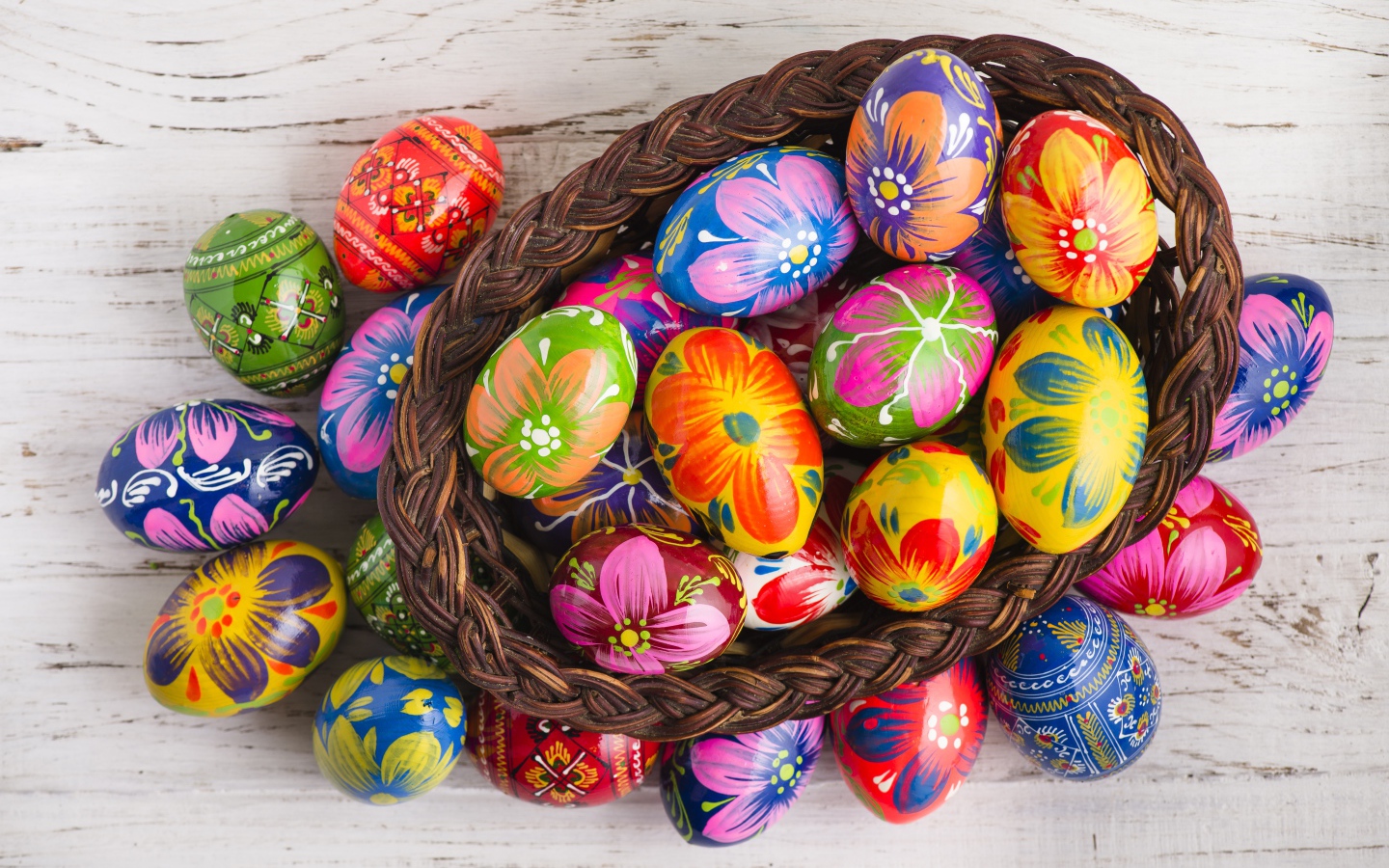 Красивые крашеные яйца в корзине на столе на праздник Великой Пасхи