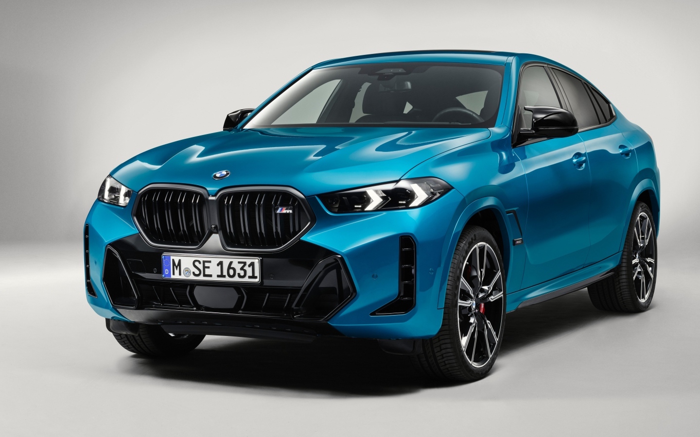 Автомобиль  BMW X6 2023 вид спереди на сером фоне