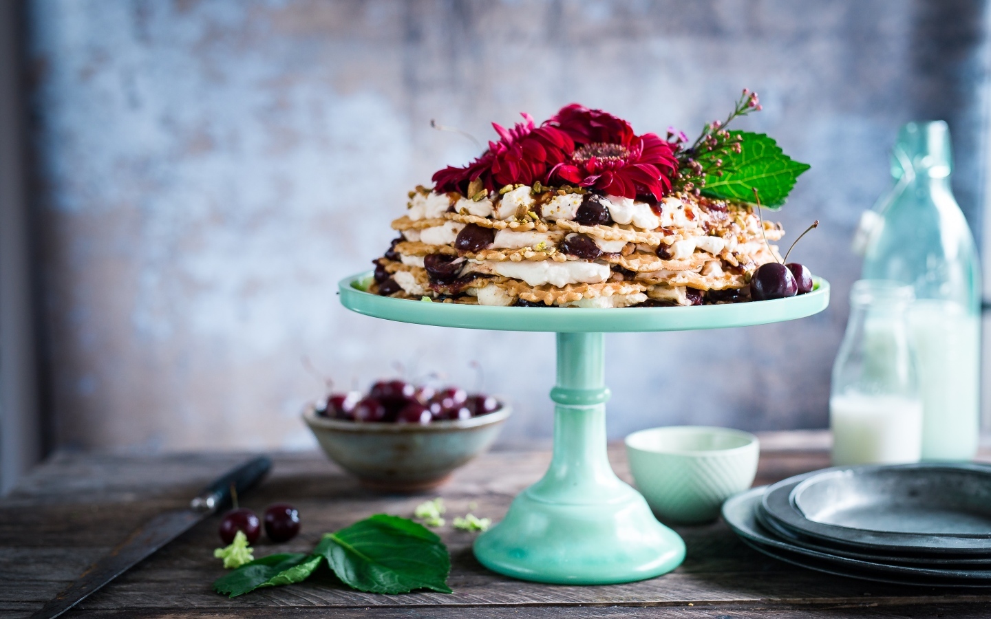 Торт с черешней и цветами герберы на столе