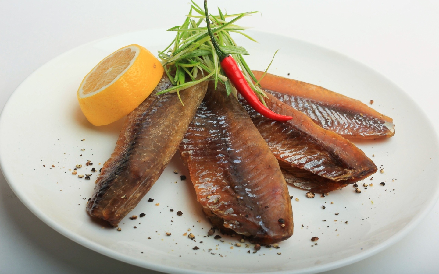 Вяленая вобла с куском лимона на тарелке