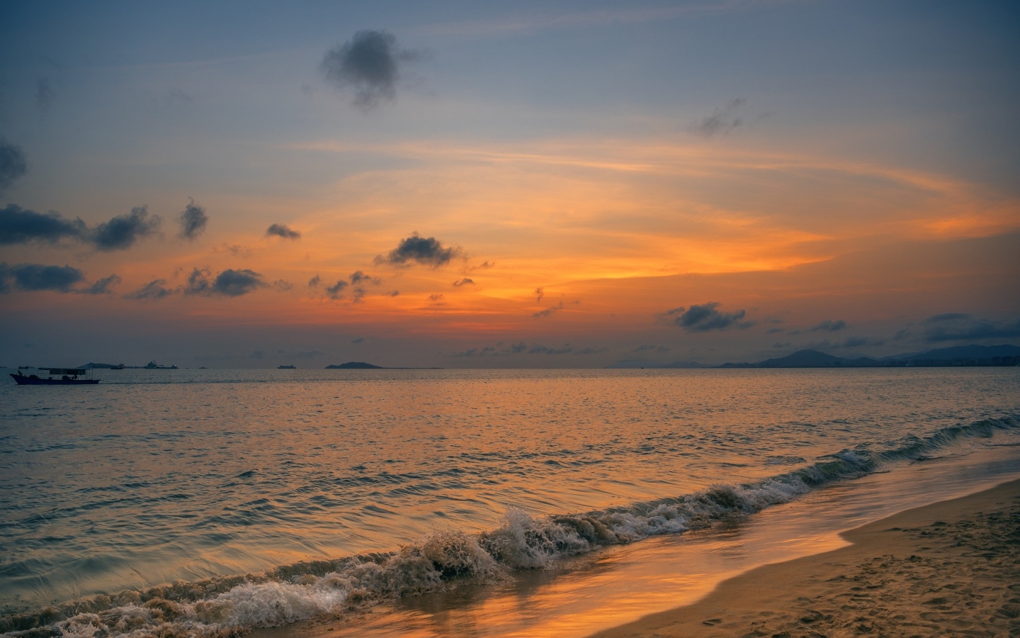 Морские волны омывают берег на закате