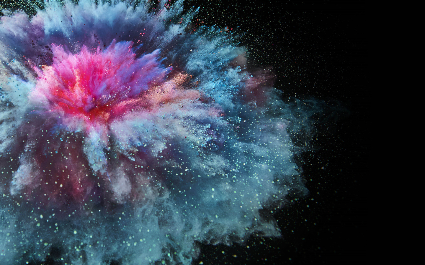 Взрыв разноцветной порошковой краски на черном фоне