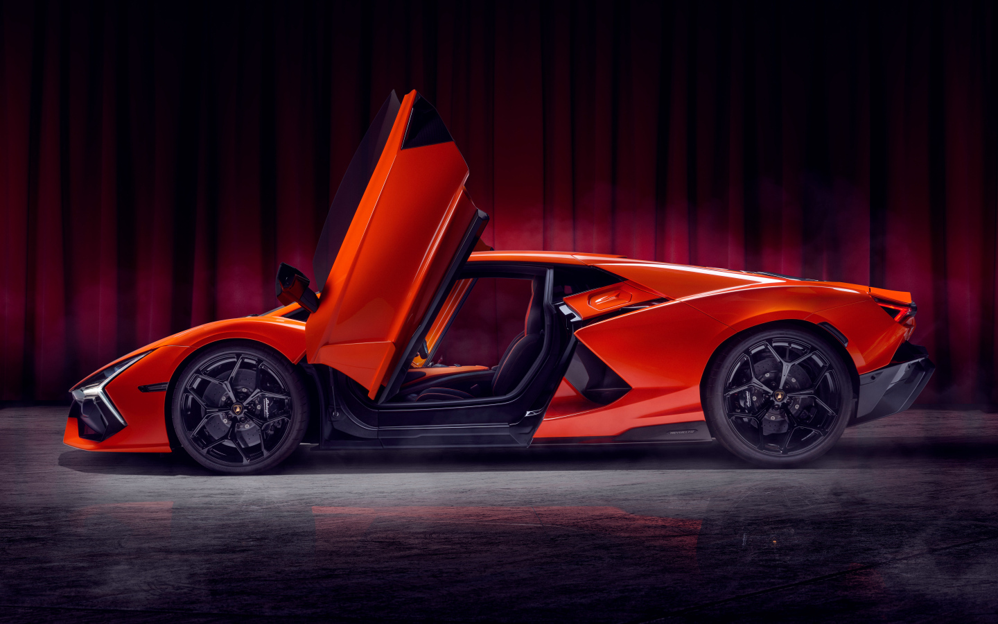 Красный автомобиль Lamborghini Revuelto с открытыми дверями