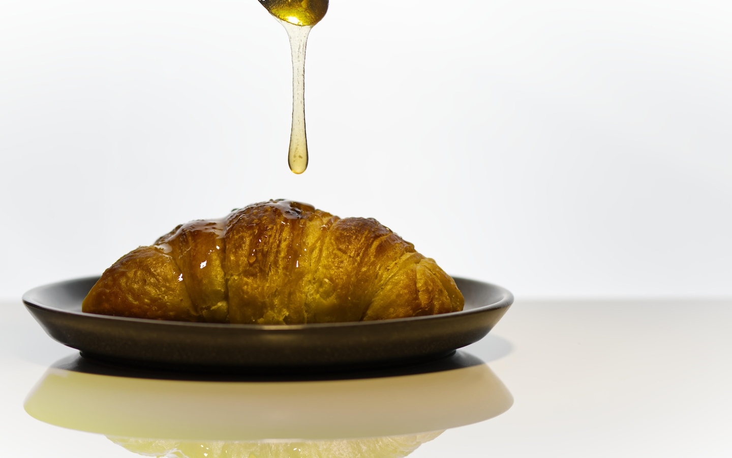 Свежий круассан с медом на завтрак