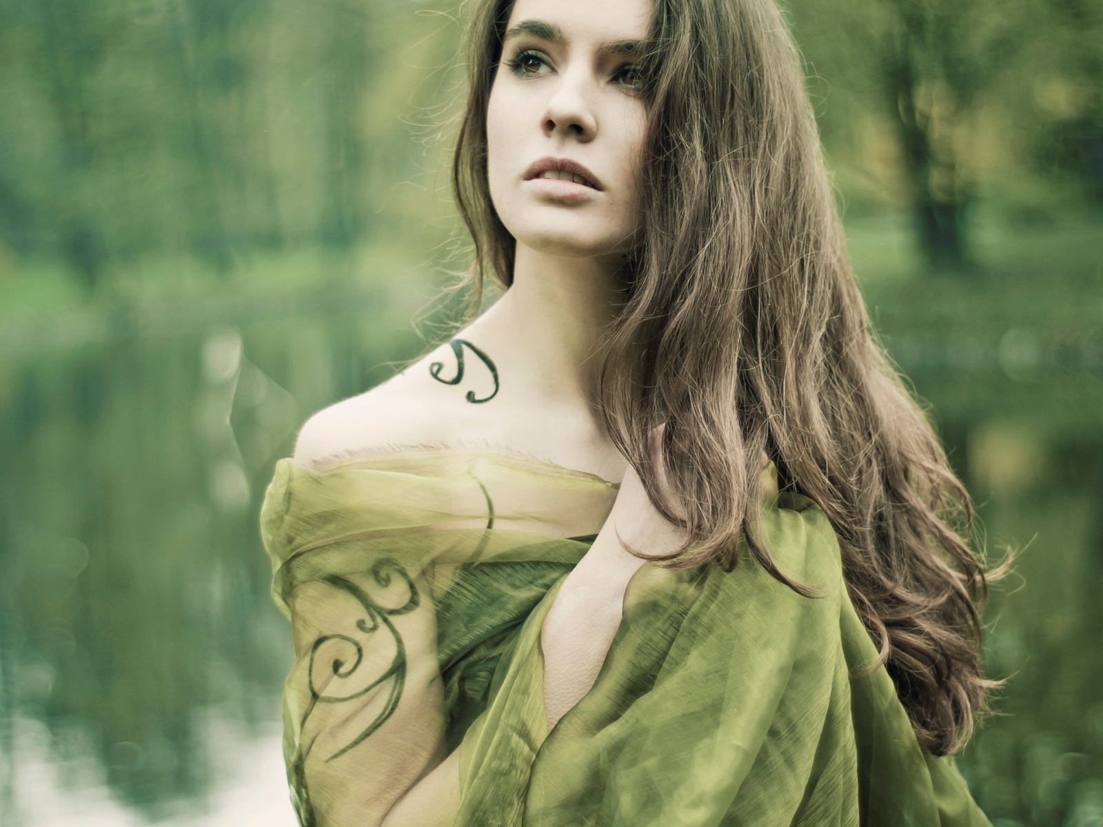 Девушка на природе с татуировкой на руке