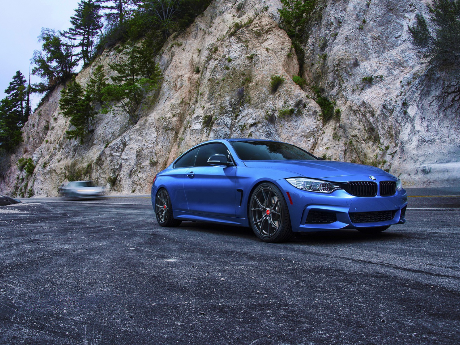 Голубой BMW M4 на фоне скалы