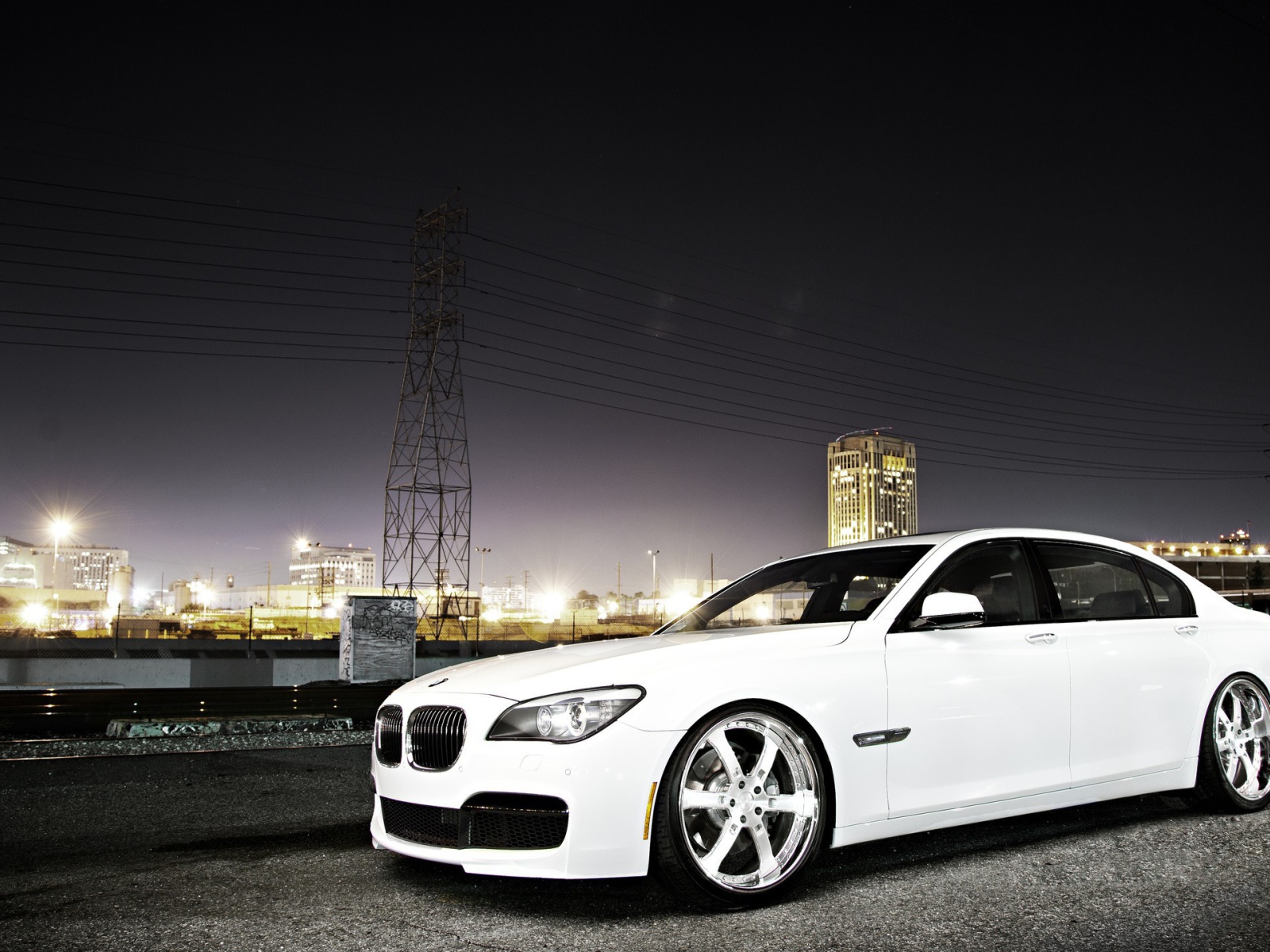Белый БМВ на фоне ночного города