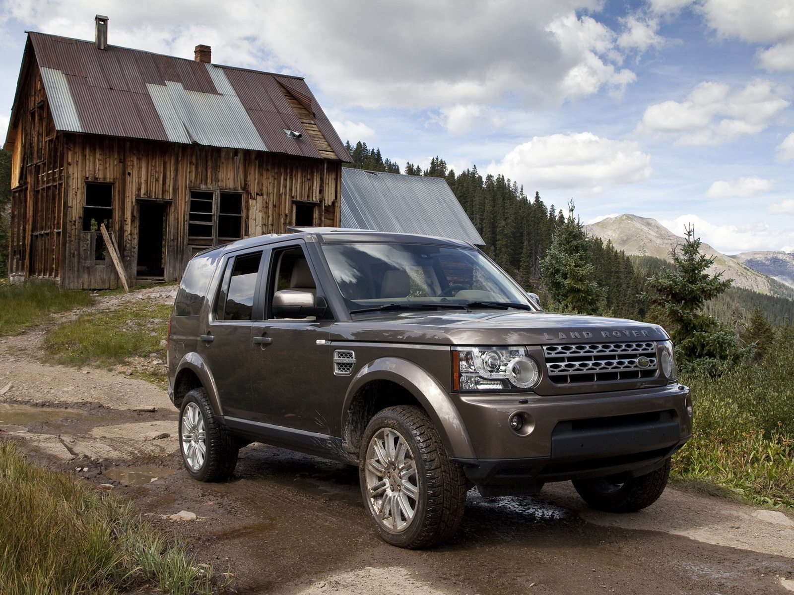 Темный Land Rover на фоне старого здания