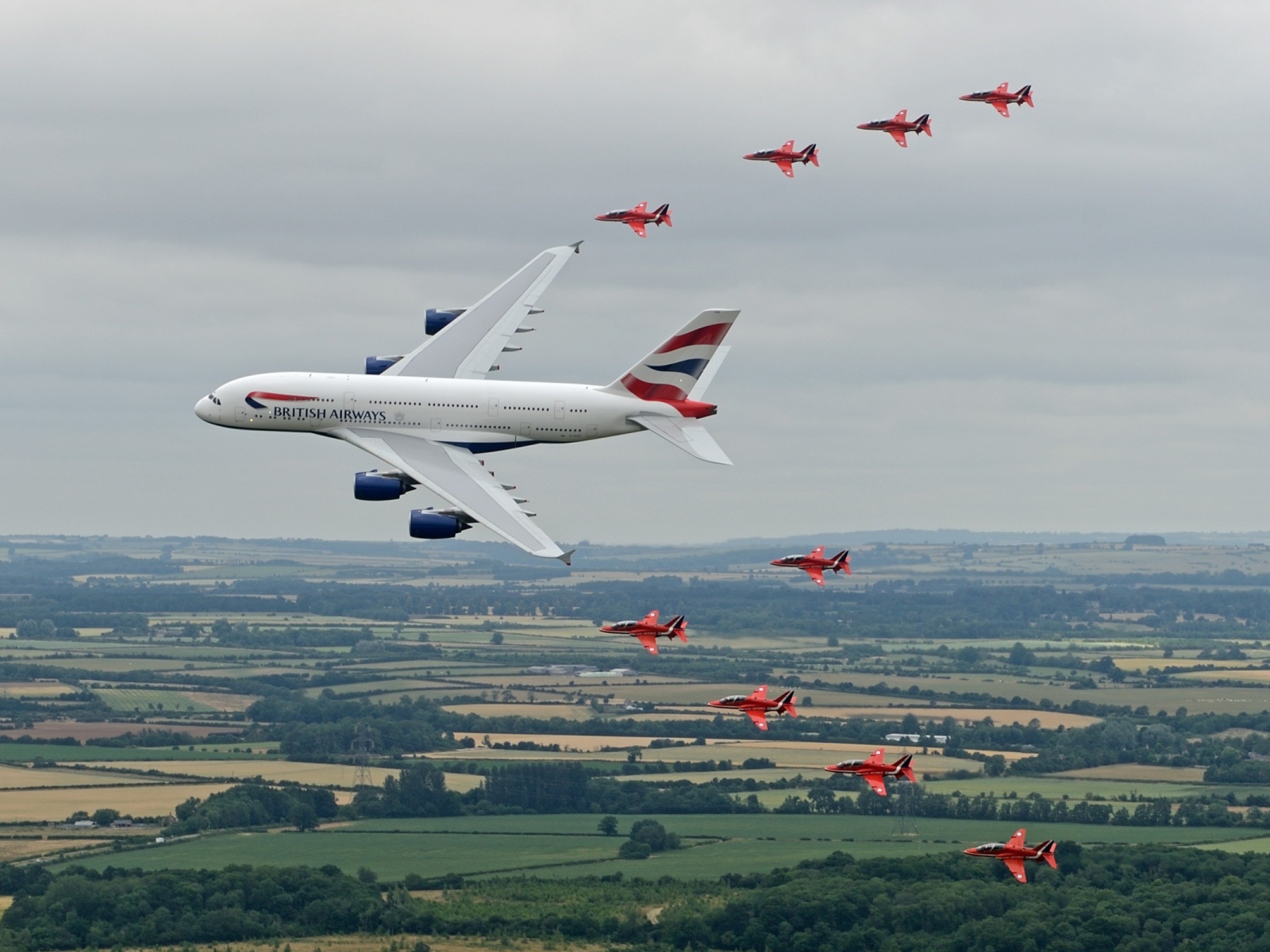 Airbus A380 в сопровождении красных истребителей