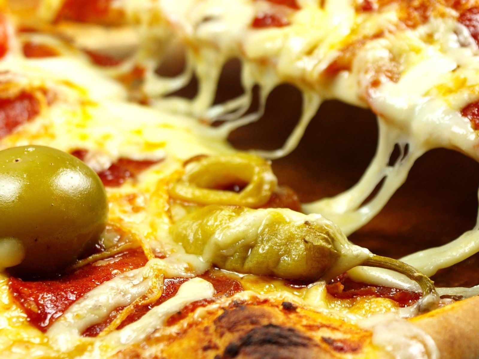 Pizza with cheese and green olives