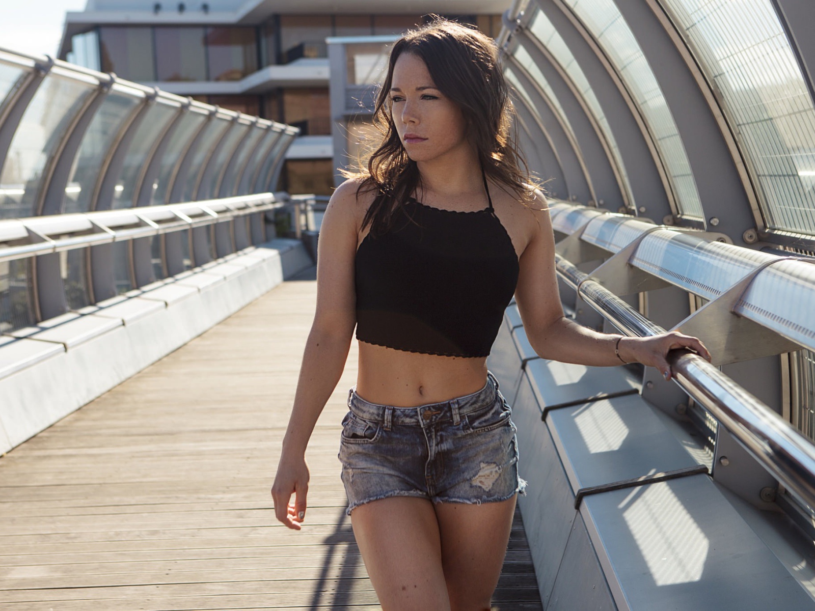 Girl in denim shorts on the bridge